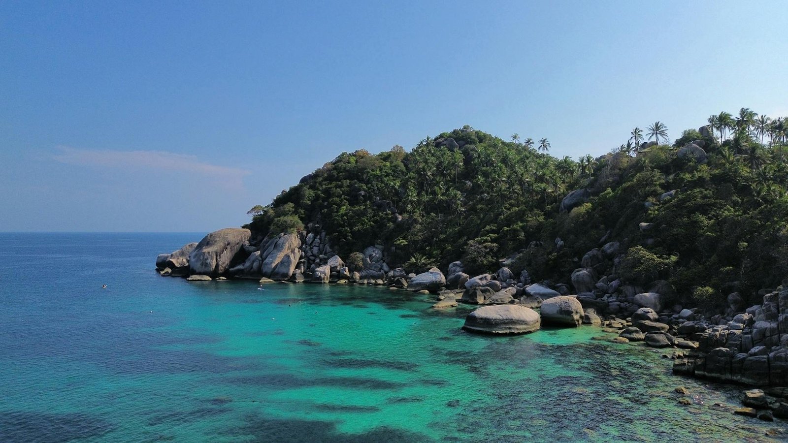 Rocky bay with palms and turquoise water, Thailand